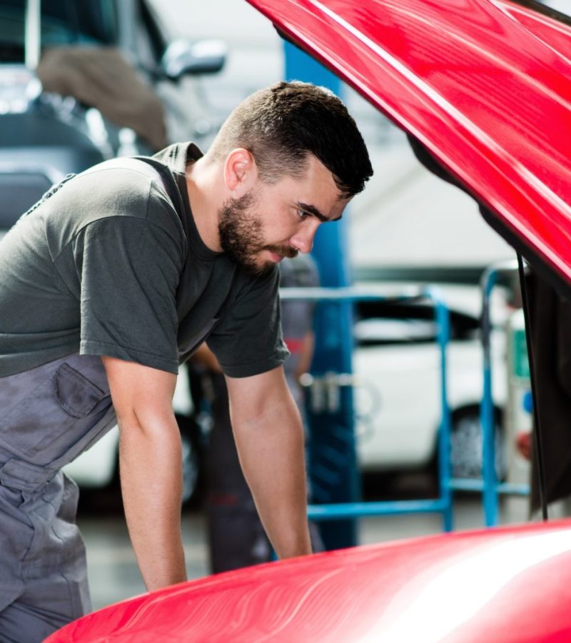 Auto mechanic working in garage. Repair service looking at the car’s motor. – Image Auto mechanic working in garage. Repair service looking at the car's motor. - Image